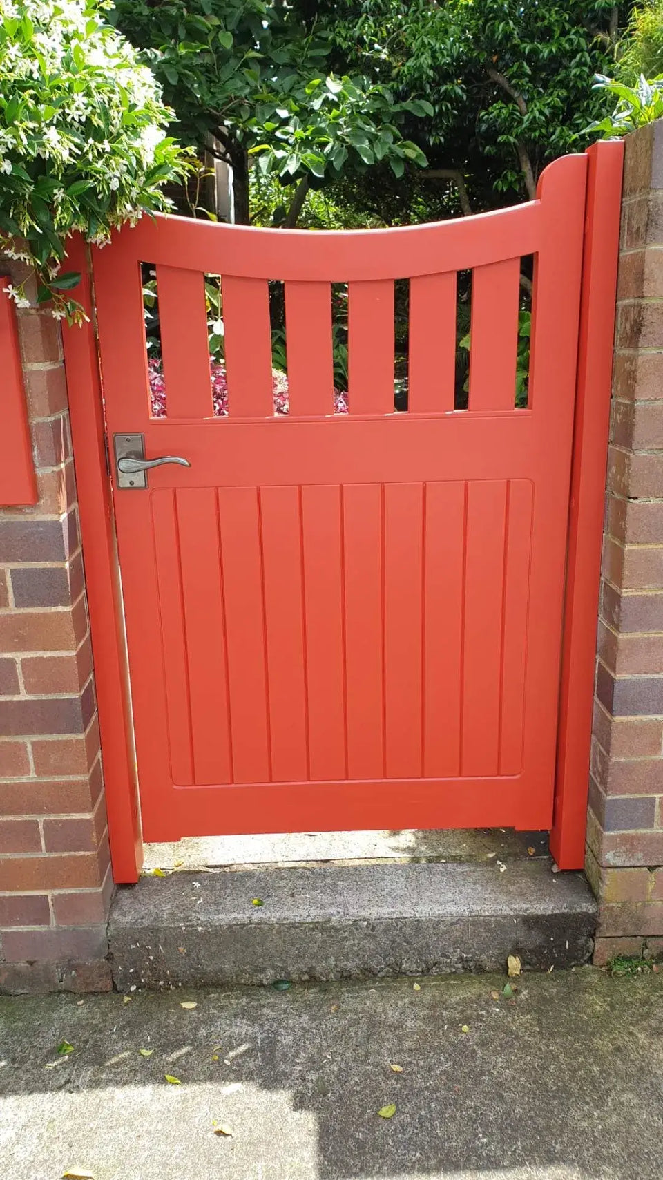 Timber pedestrian gate with downward curved top