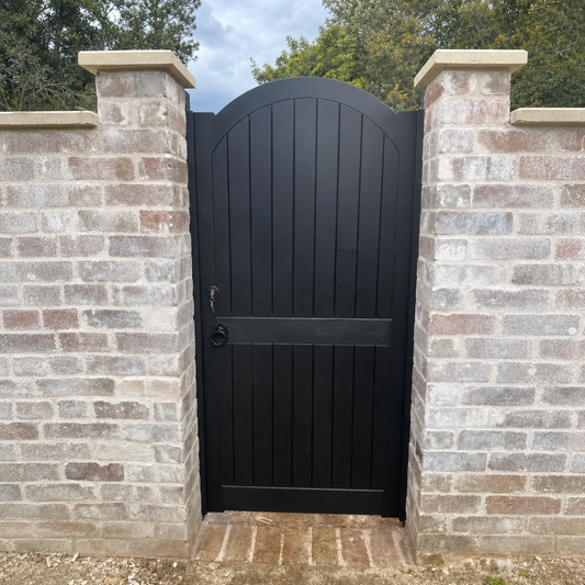 Front view of Collaroy solid timber pedestrian gate with upward curve