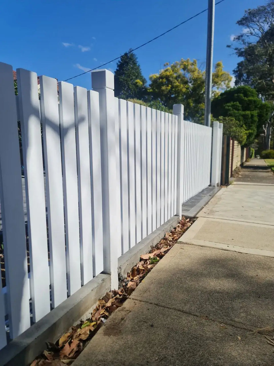 Fine timber picket gate in a matching painted run
